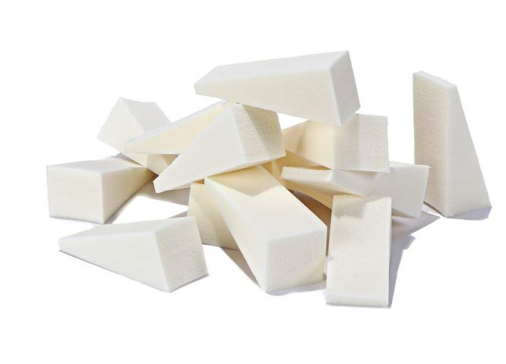 piles of white triangle-shaped makeup sponges