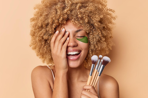 a lady holding the makeup brush and laughing happily