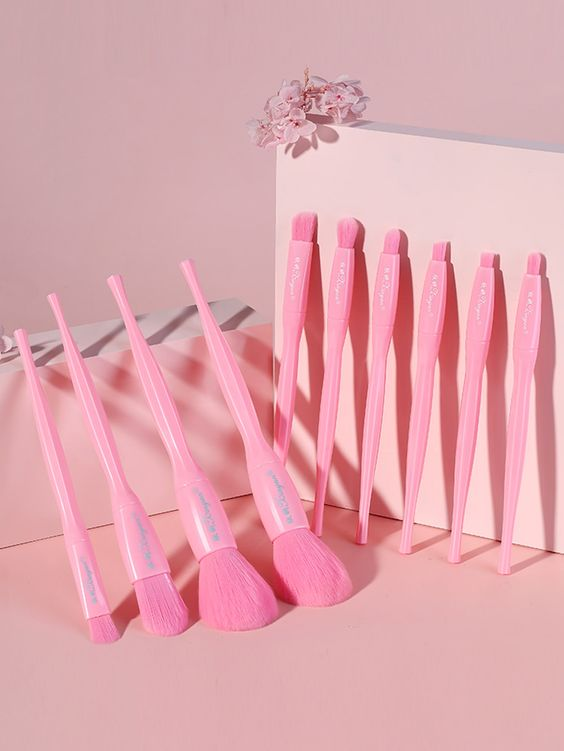 many makeup brushes in pink color