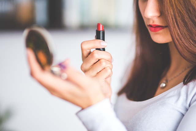 a woman applying on the solid lipstick