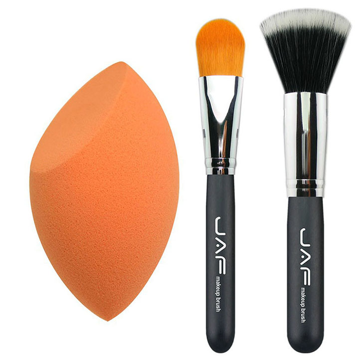 two make up brushes and one make up sponge