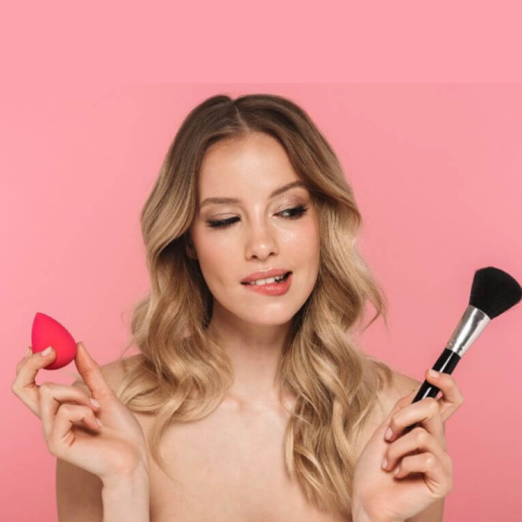 a lady handing a makeup sponge and a brush