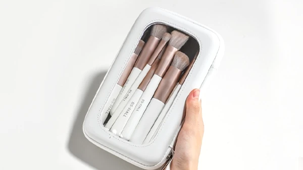 Portable white makeup brush packaging pouch featuring a clear transparent window.